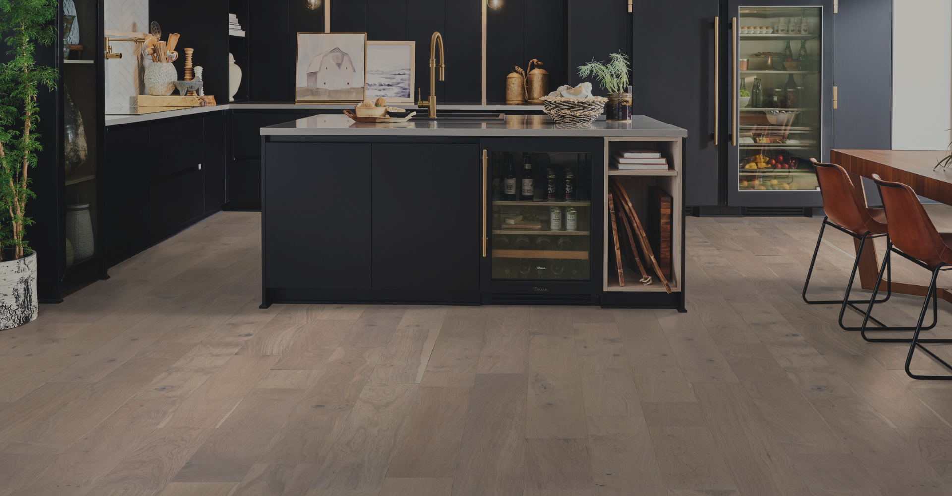 hardwood flooring in a modern kitchen with navy blue cabinetry and gold accents