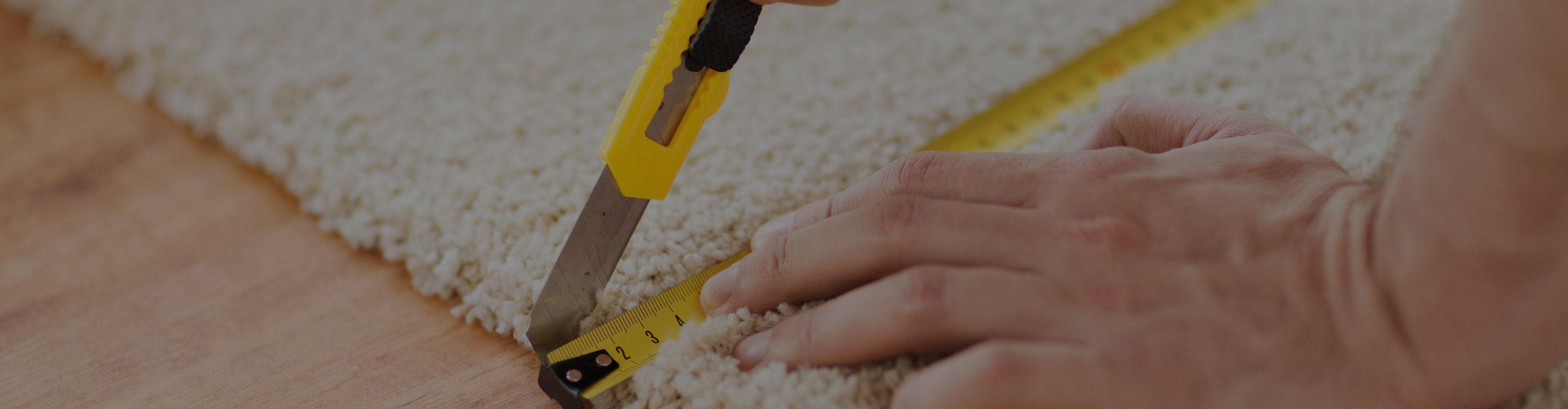 Closeup of area rug cutting and measuring 