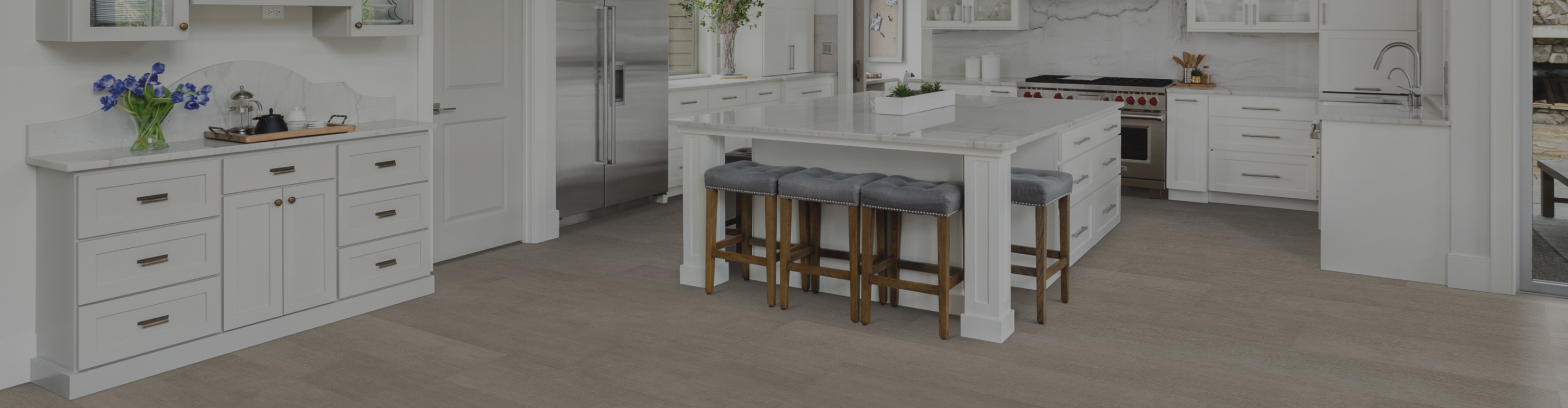 wood-look flooring in a kitchen with white cabinetry